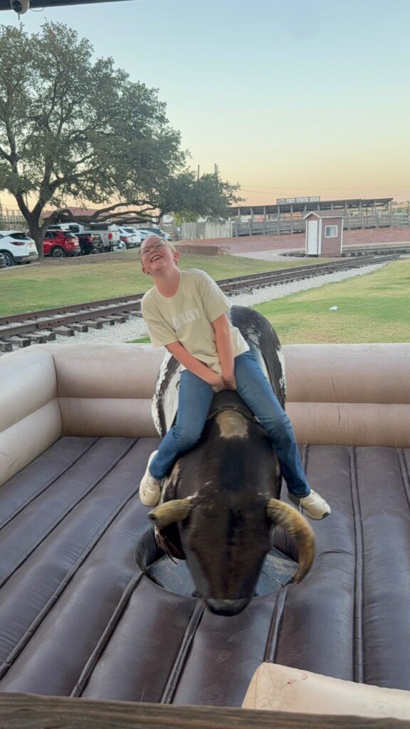 Girl riding mechanical bull