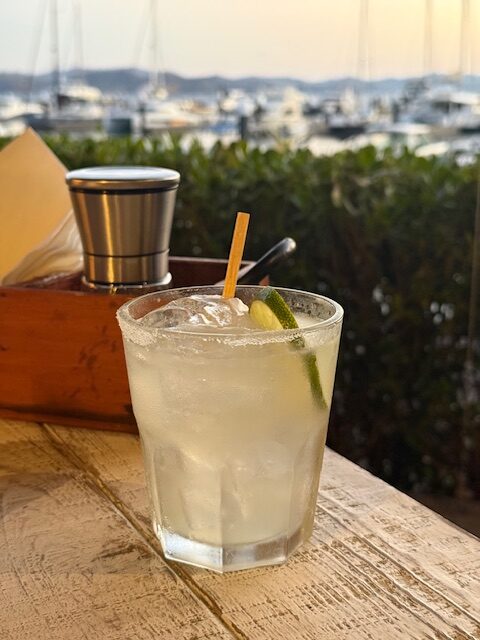 Margarita on table with marina in background