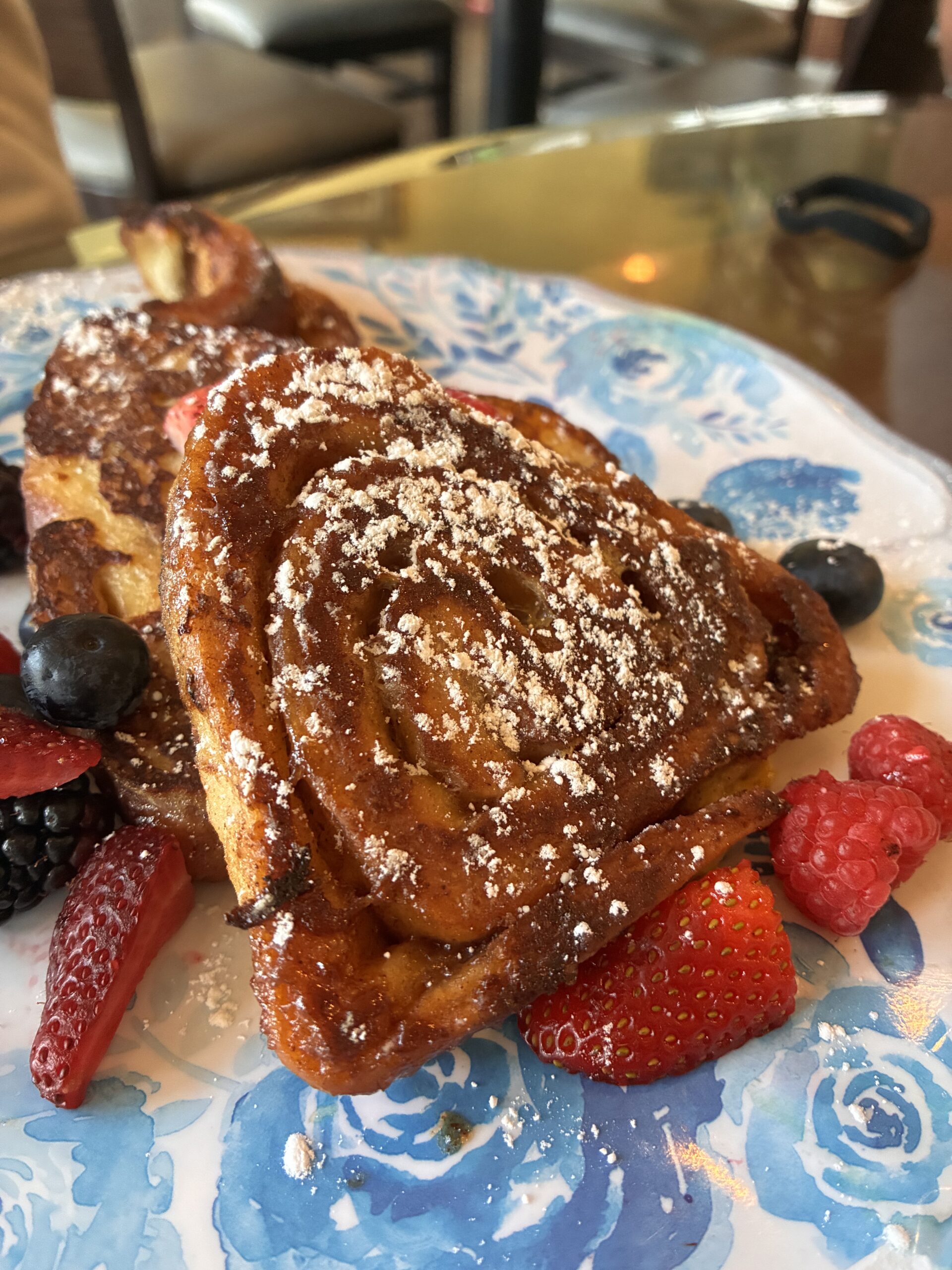 Cinnamon Roll Pancakes on blue and white plate
